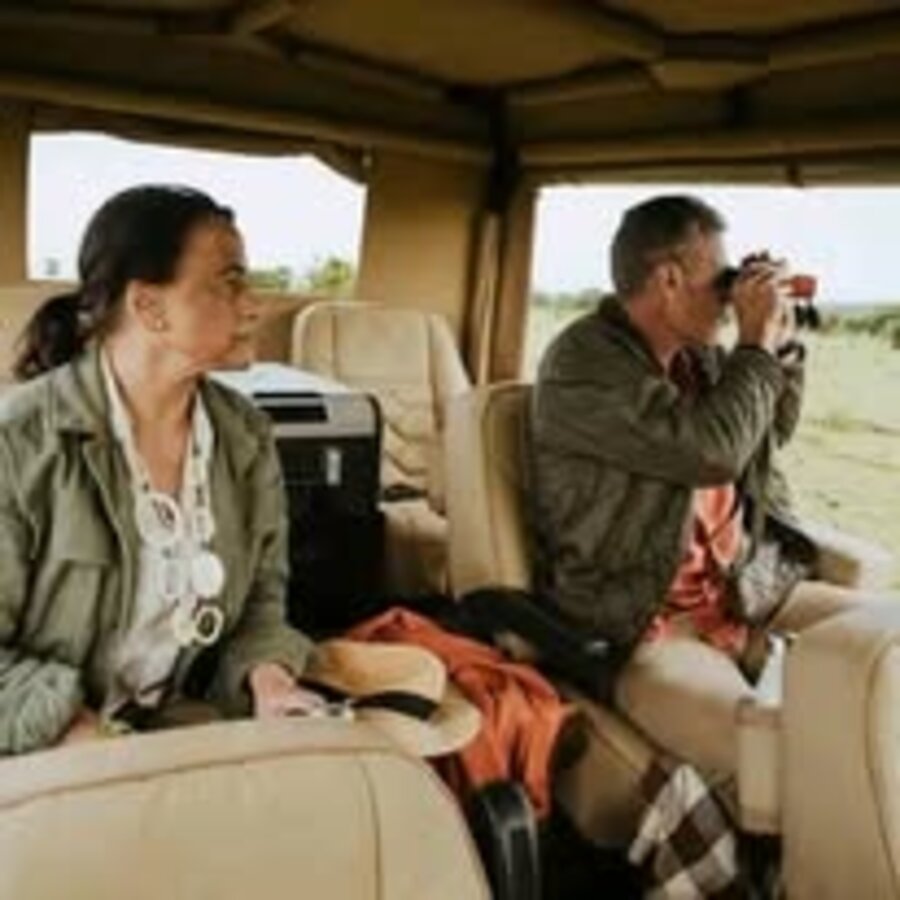 Tourists on a safari vehicle in Kenya